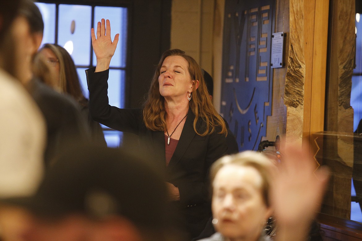 Kootenai County Commissioner Leslie Duncan sings worship music along with a crowd of supporters at John Padula's campaign party at Lyfe Coffee Tuesday night.