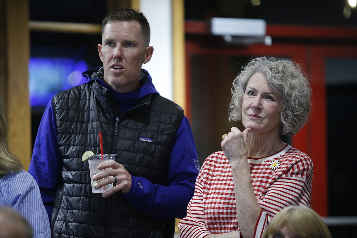 Aaron O'Brien, Republican winner for precinct #320, watches the first batch of absentee votes roll in alongside Sandy Patano at the Coeur d'Alene Public Golf Club.