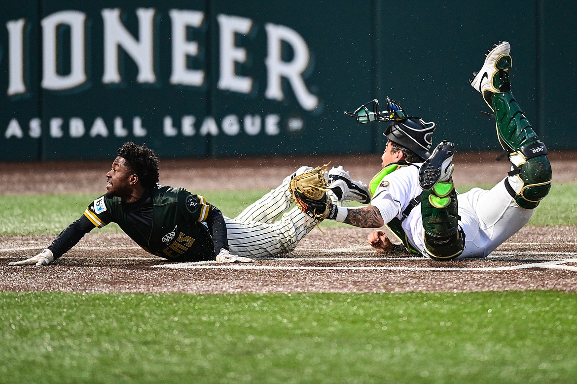 Oakland's Payton Harden (1) slides in ahead of the tag by Glacier Range Rider catcher Drew Sims at Glacier Bank Park in Kalispell, Montana on Tuesday, May 21. (Casey Kreider/Daily Inter Lake)