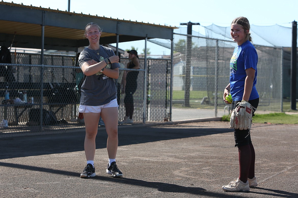 Former Moses Lake High School softball player and 2023 Covenant Christian School graduate Ali Stanley, left, talks with Royal sophomore Jill Allred during a May 10 practice in Royal City. Stanley has been coaching with the Knights this season after Big Bend’s softball season was canceled last fall.