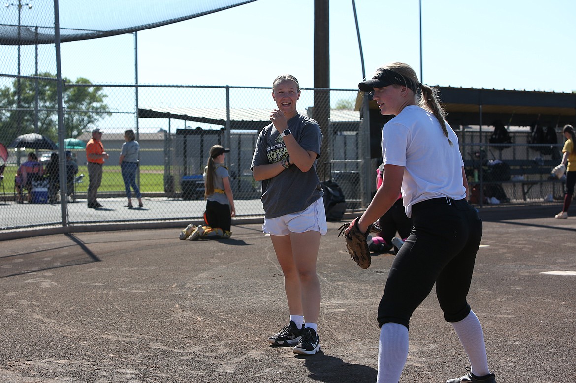 Royal Assistant Coach Ali Stanley, in gray, works with Royal players on fielding ground balls during a May 10 practice. Royal Head Coach Lisa Lawrence praised Stanley’s ability to work with a variety of position groups.