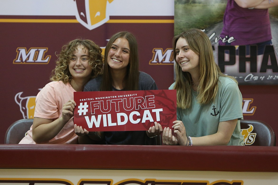 Moses Lake senior Sylvie Gephart, center, smiles for photos at her signing ceremony on Tuesday afternoon. Gephart signed to run cross country and track at Central Washington University.