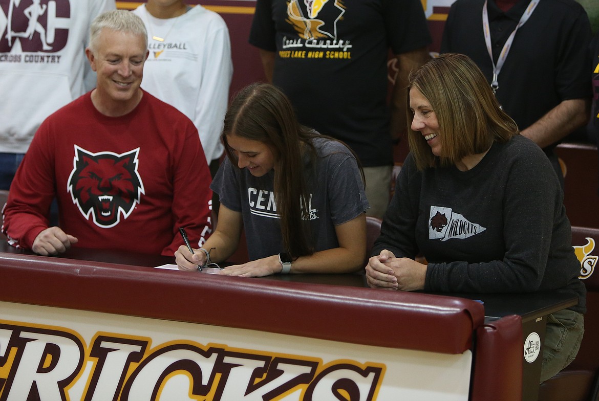 Moses Lake senior Sylvie Gephart, center, signs her letter of intent to run cross country and track at Central Washington University. Gephart said she decided on Central after seeing their facilities, and wanting to join a program on the rise.