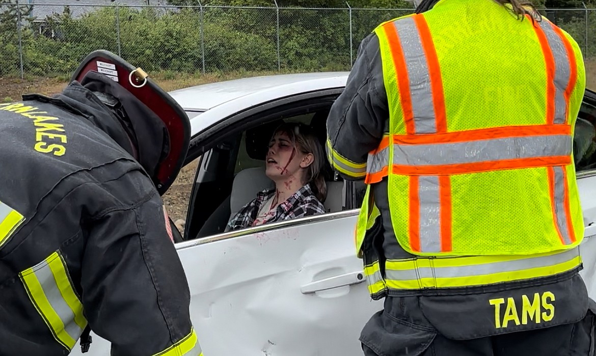 Ashara Evans cries out as firefighters assess her after a mock DUI crash at Timberlake High School Wednesday morning.