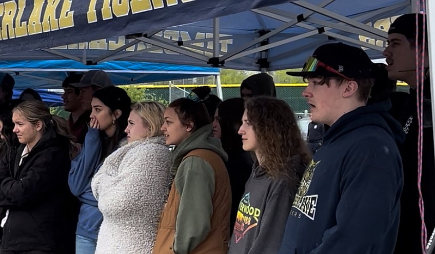 Timberlake High School students watch with visible emotion as a mock DUI crash takes place and law enforcement and firefighters assess student victims and examine the scene of the crash.