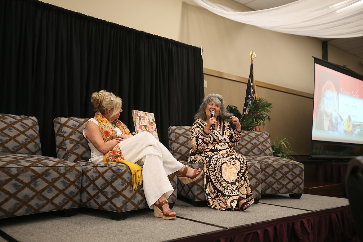 Kerri Thoreson speaks to the crowd about her silver hair Wednesday as she is seated next to North Idaho Alliance founder and CEO Marilee Wallace at the Onward and Upward Women's Conference at the Best Western Plus Coeur d'Alene Inn. Thoreson was named the 2024 Woman of Impact at the event.