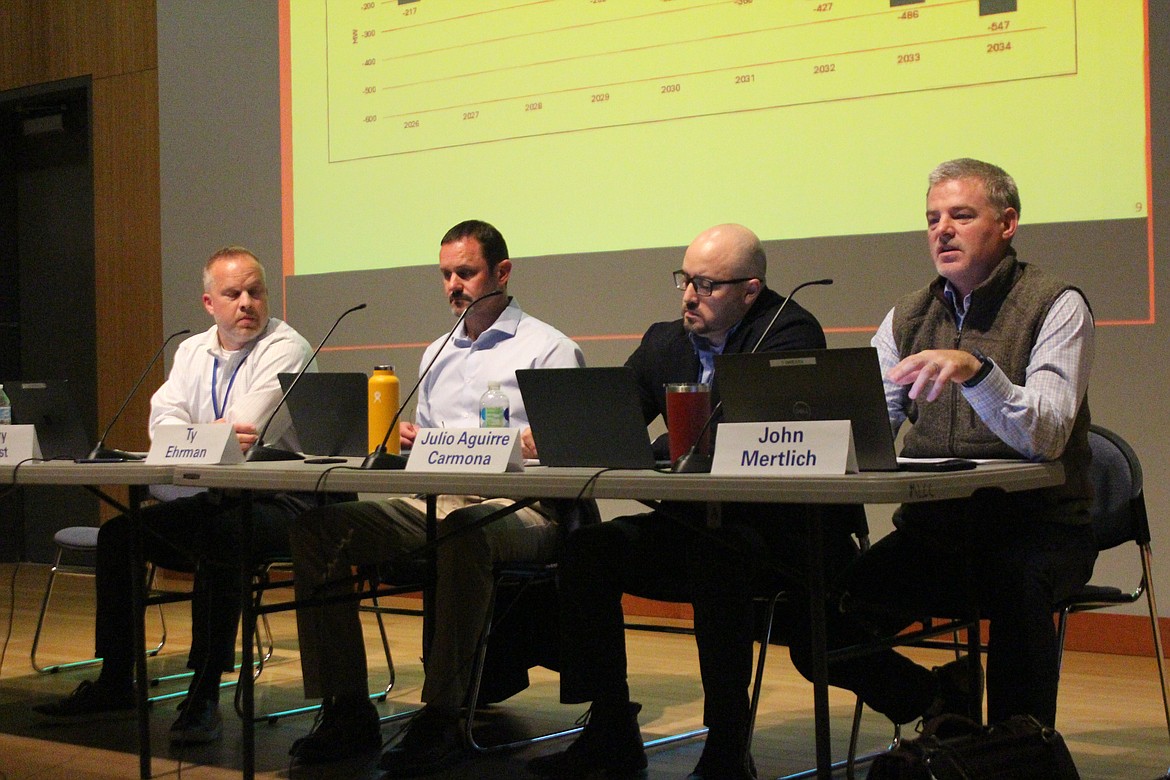 John Mertrlich, right, explains utility forecasting during a meeting on Grant County PUD rates Tuesday. From left, Cary West, Ty Ehrman and Julio Aguirre also participated on the panel.