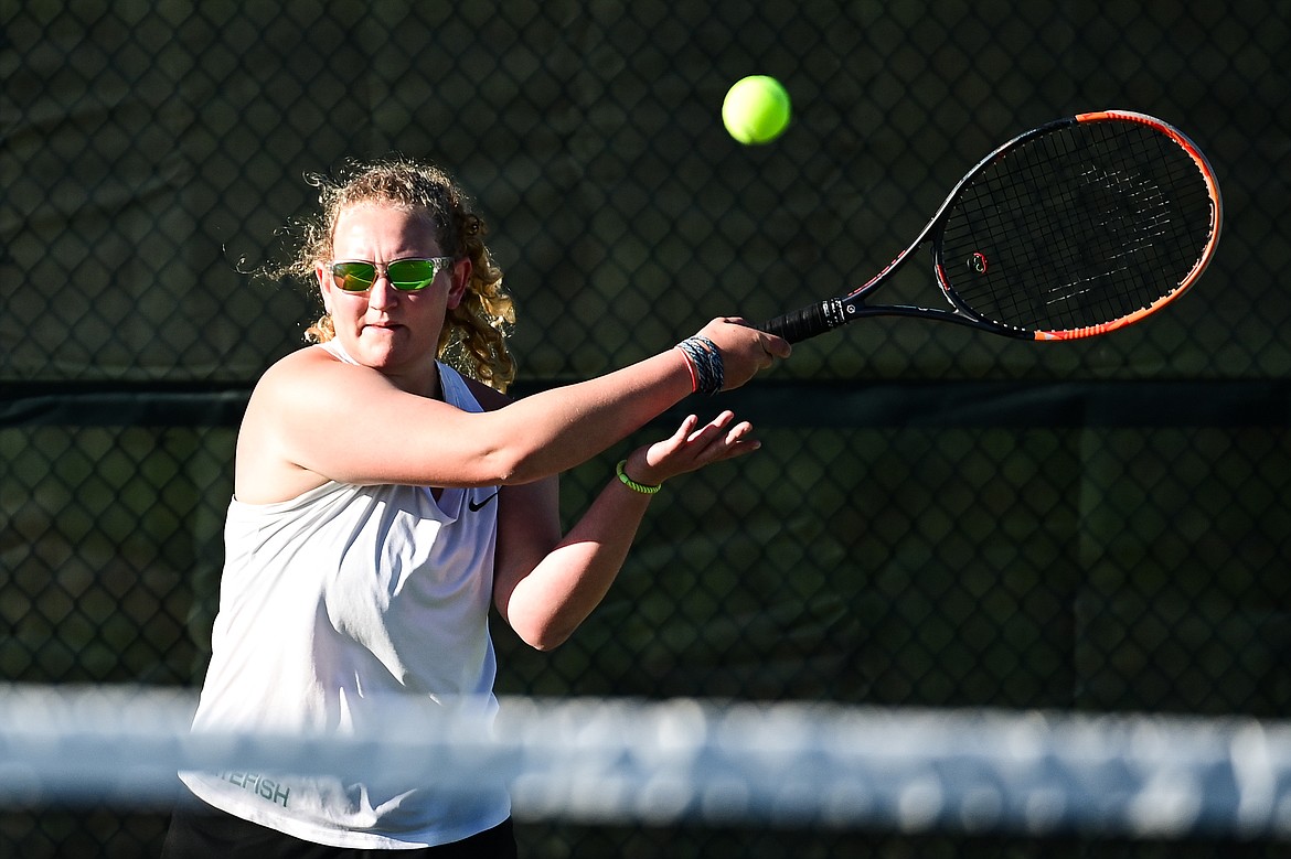 Whitefish's Ainsley Scott hits a return in a girls doubles match with teammate Maggie Mercer against Lewistown's Lexi Breidenbach and Lauren Plagenz at the Class A State Tennis Tournament at FVCC on Thursday, May 13. (Casey Kreider/Daily Inter Lake)