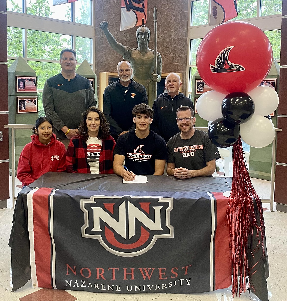 Courtesy photo
Post Falls High senior Alex Shields recently signed a letter of intent to compete in track and field at NCAA Division II Northwest Nazarene University in Nampa. Seated from left are Angeley Shields, Carolina Shields, Alex Shields and Dan Shields; and standing from left, Craig Christensen, Post Falls High athletic director; Marc Allert, Post Falls High assistant track and field coach; and Wade Quesnell, Post Falls High head track and field coach.