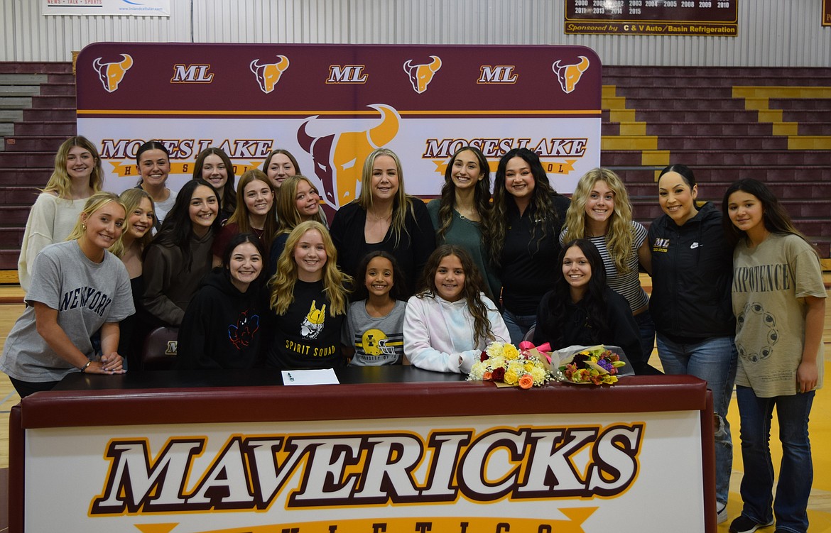 Moses Lake High School senior Kamaya Villegas, sitting second from the left, gathered with her friends, family and coaches to celebrate her signing to the University of Idaho’s Vandal Spirit Squad.