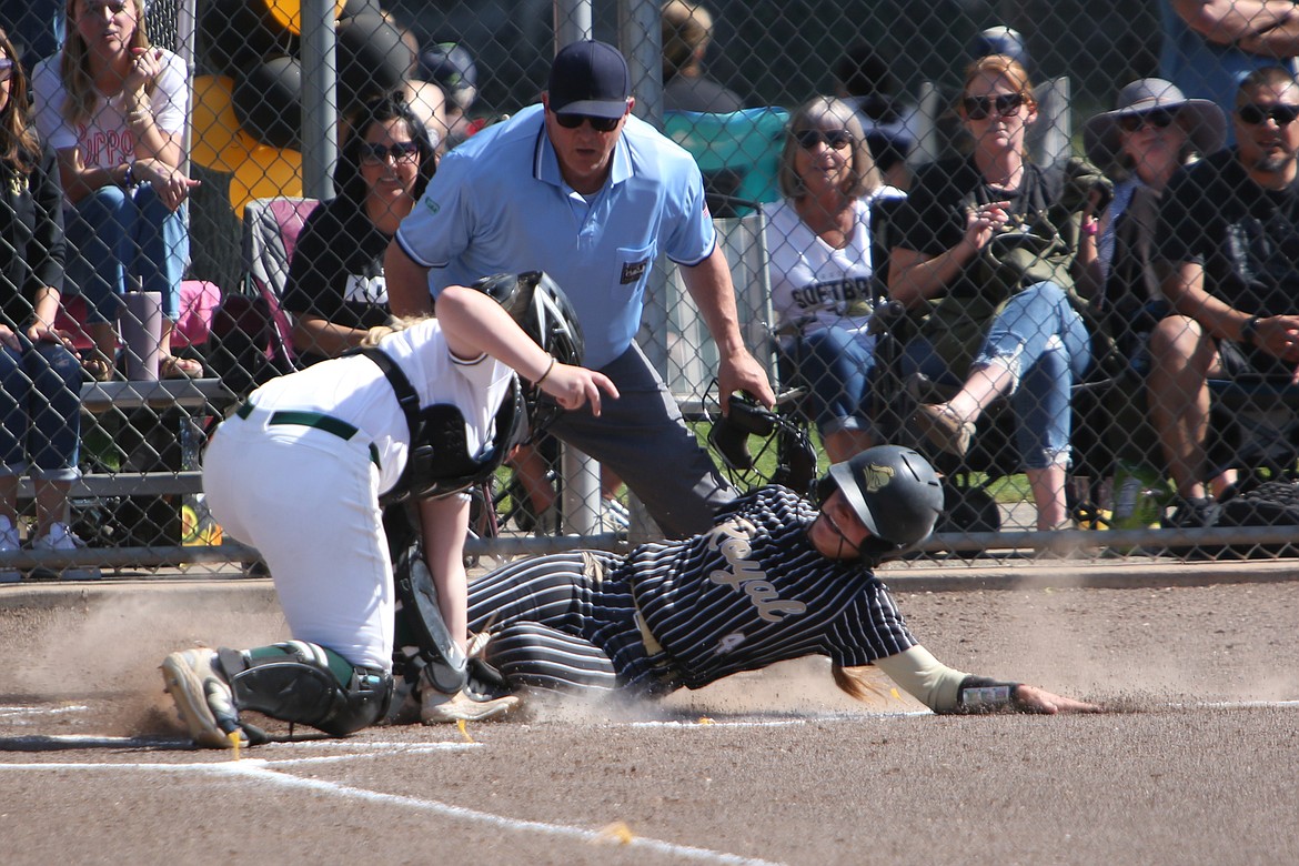 Royal senior Raegan Wardenaar (4) slides into home plate to score a run in Thursday’s 10-0 win over Klahowya in the 1A State Softball Tournament. Wardenaar led the Knights with four RBI in the win.