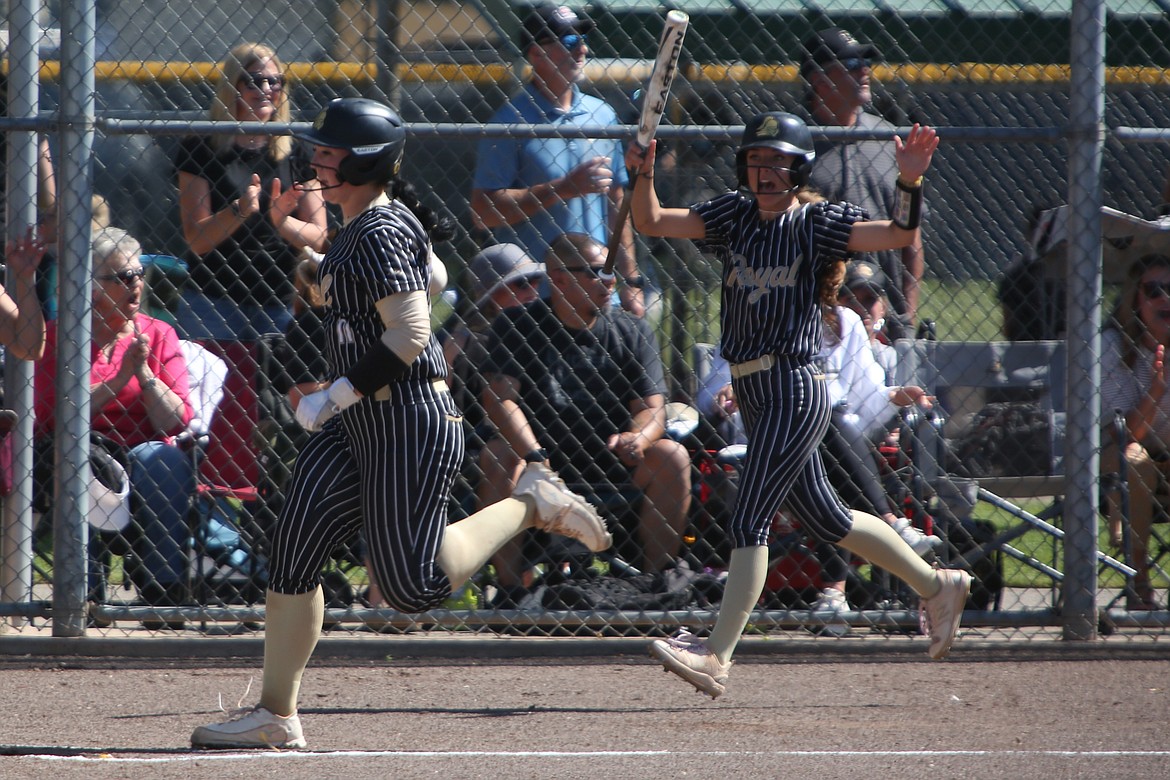 Royal senior Randi Allred, left, runs to home plate while senior Jaya Griffin, right, celebrates in the bottom of the second inning.