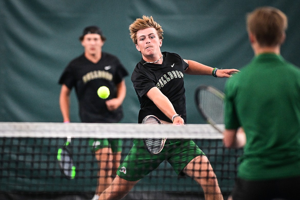 Whitefish's Dane Hunt plays a shot at the net in a boys doubles match with teammate Mason Kelch against Billings Central's Braydon Petermann and Aiden Sorenson at the Class A State Tennis Tournament at Logan Health Medical Fitness Center on Friday, May 24. (Casey Kreider/Daily Inter Lake)
