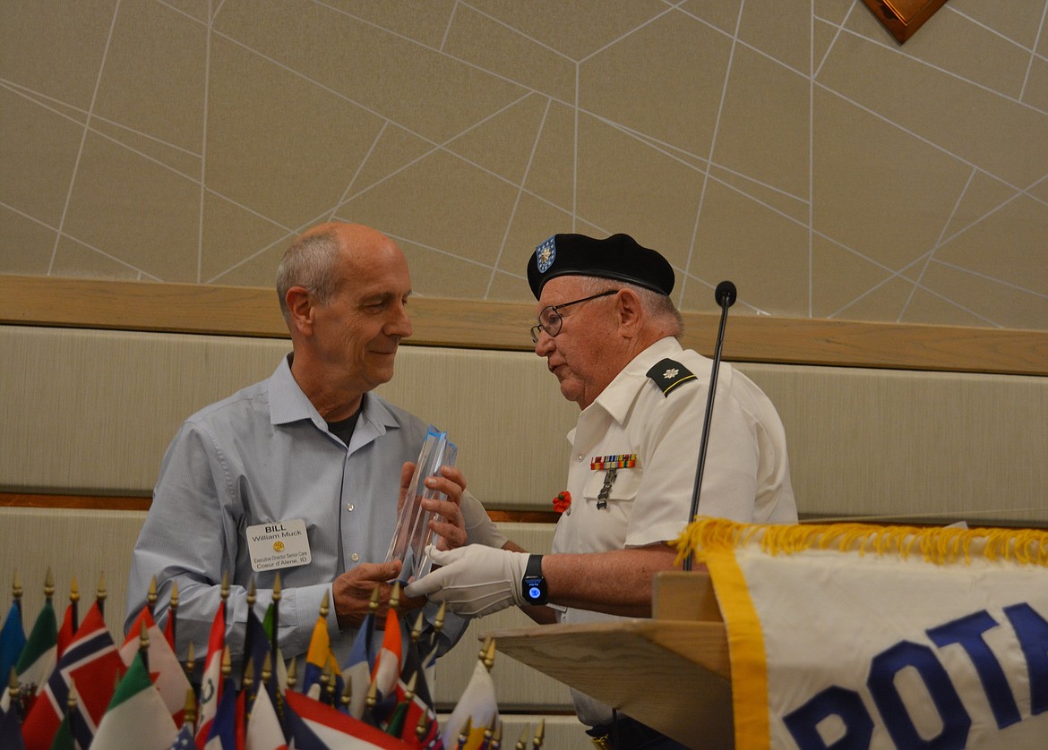 Rev. Bill Muck accepts the Gold Star Award from Bob Smee during a Rotary Club meeting. Muck served as a pilot in the Air Force and performs many invocations for veteran events in the area.