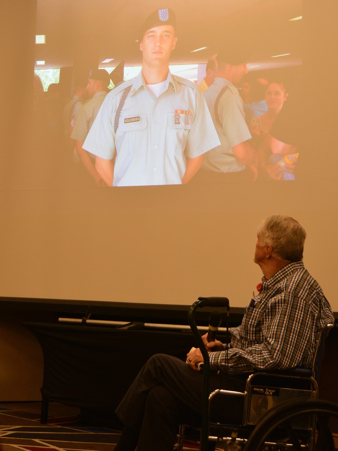 John Goldsmith looks up at a photo of his son, Wyatt Goldsmith wearing his military regalia, during a slide show as part of a Memorial Day tribute honoring Gold Star families.