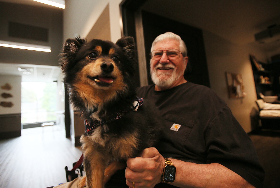 Army veteran Frank Quattrocchi, president of the Idaho State Veterans Home Post Falls Resident Council, shares a happy moment Thursday with Flash the therapy dog.
