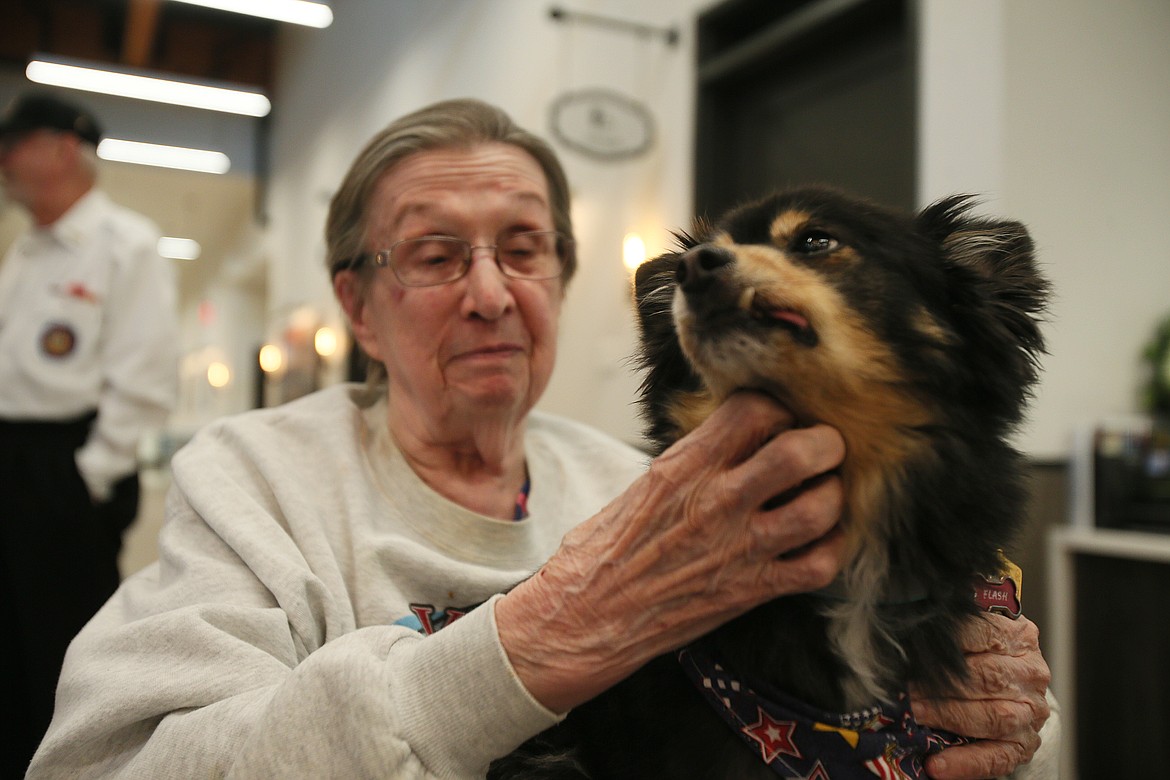 Idaho State Veterans Home Post Falls resident Mary Sears gives Flash the therapy dog a scratch under his chin Thursday morning. “He comes and visits me and he gives me kisses,” she said. "He’s wonderful."