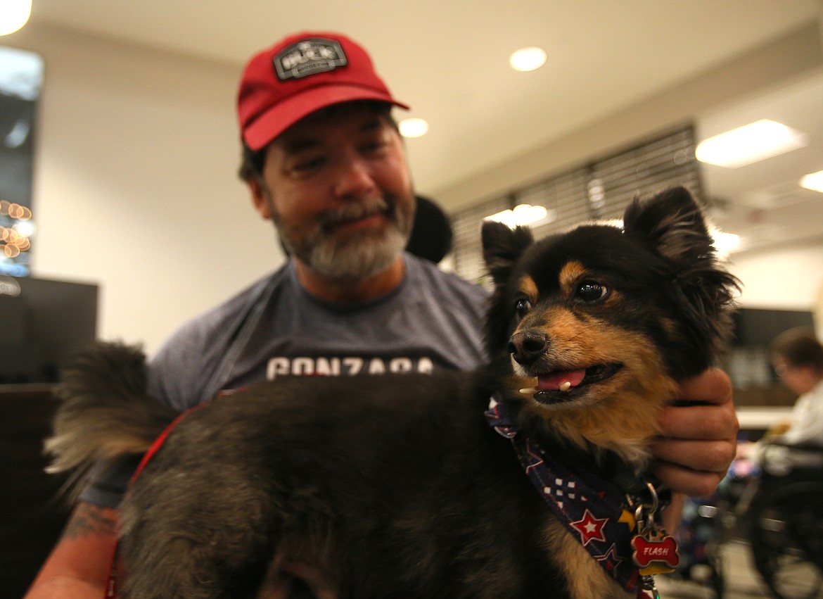 Marine Corps veteran Charlie Aebi and therapy dog Flash, pictured together Thursday morning, are good buddies and deliver the mail to residents at the Idaho State Veterans Home Post Falls.
