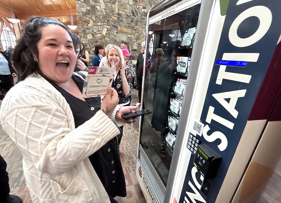 Emily Aizawa, development manager at Children's Village, smiles after using the Giving Station at The Kroc Center to support Children's Village on Friday.