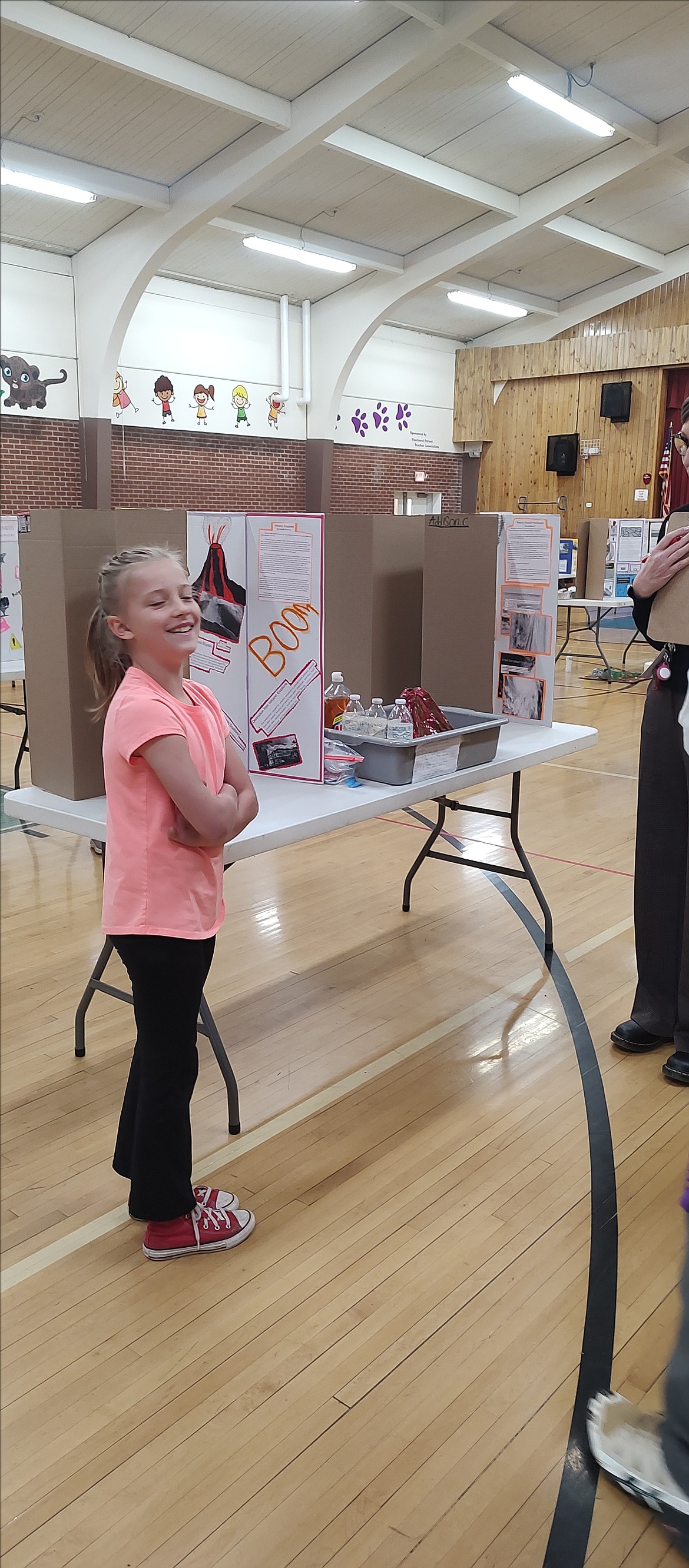 Camilla Bowman shows off her volcano exhibition during the Pinehurst Elementary School science fair.