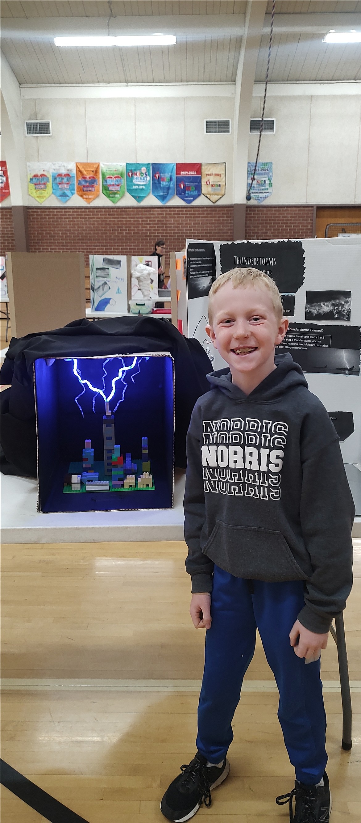 Owen Norris presents his thunderstorm natural disaster exhibit at Pinehurst Elementary School.