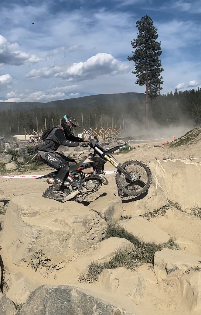 Howard attempts to clear a rock bed during an EnduroCross race.