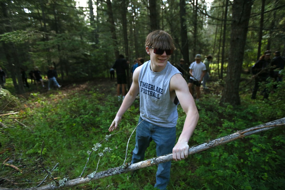 Fisher Timmins, a freshman at Timberlake High School, clears deadfall with his classmates Friday morning at Farragut State Park during the annual Timberlake Community Appreciation Day.