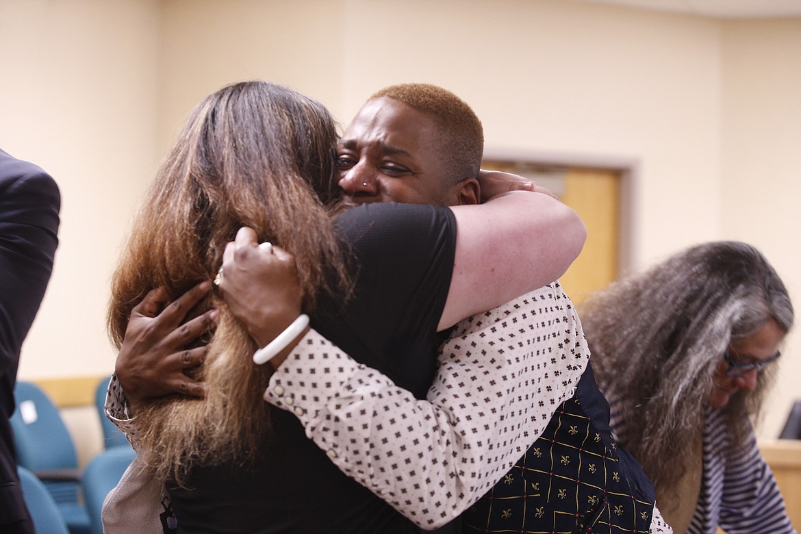 Eric Posey tearfully embraces a supporter after the jury awarded him more than $1.1 million in damages for defamation.