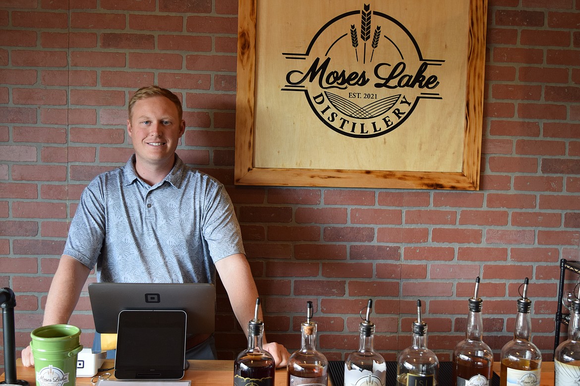 Moses Lake Distillery Owner Zachary Hughes stands at the counter of the distillery’s small tasting room in downtown Moses Lake