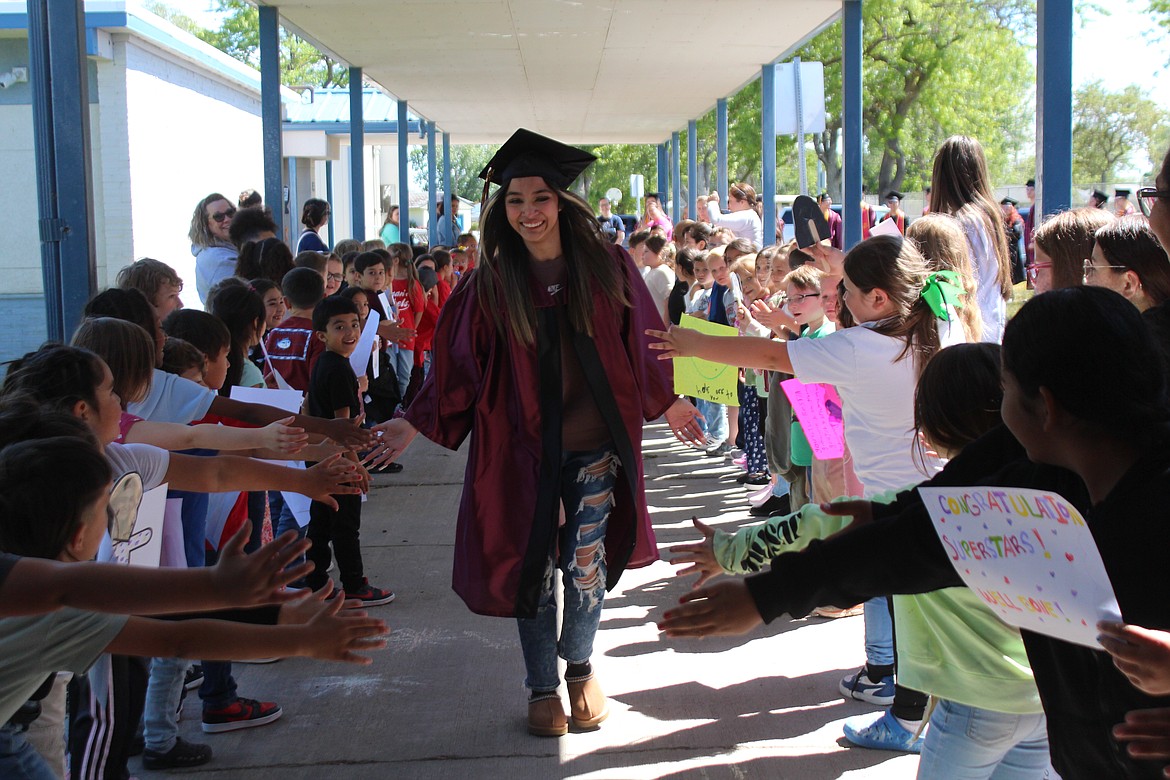 Moses Lake High School seniors high-fived nearly every student at Peninsula Elementary, showing children at their old high school that they too can achieve and succeed.