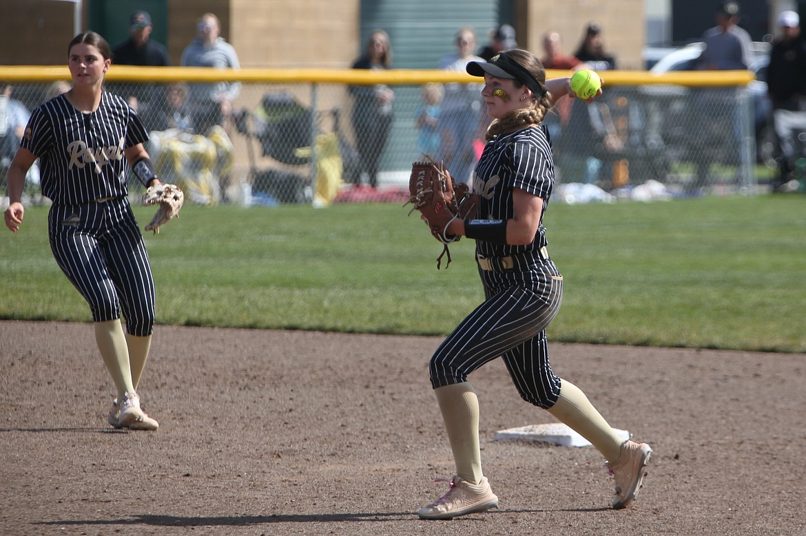 Royal sophomore Emerson Eilers, right, throws the ball back to first base for an out during Saturday’s state semifinal game against Cedar Park Christian. Eilers hit a go-ahead two-RBI double against Montesano on Friday to send the Knights to the semifinal round.