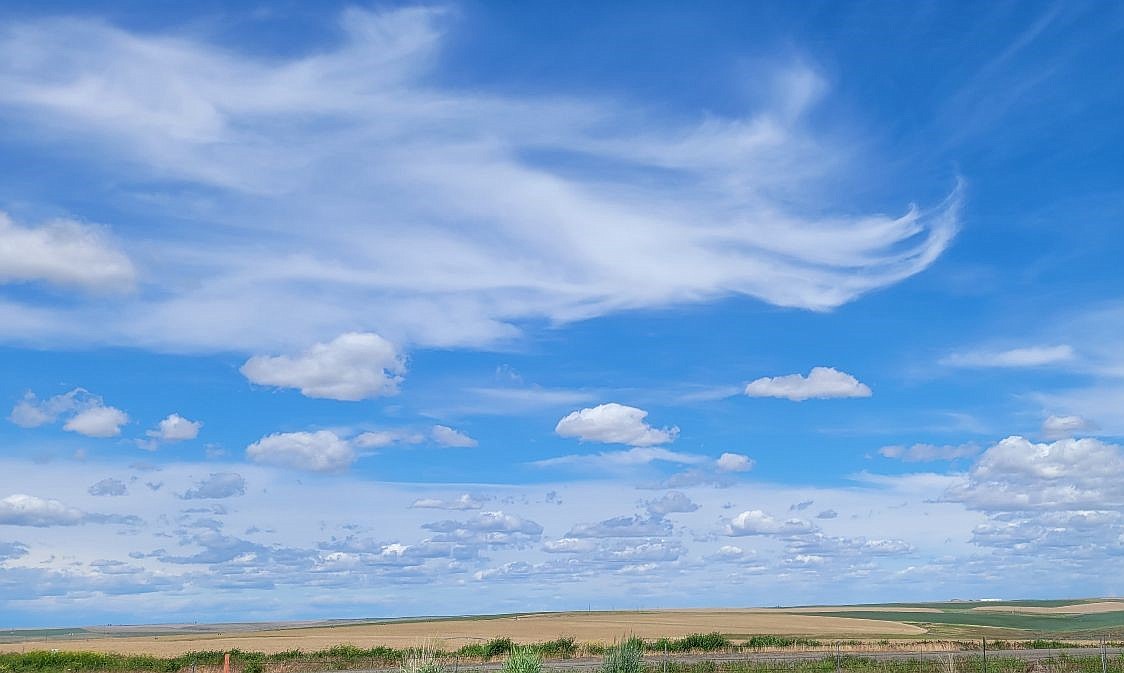 Sun shines and light clouds swirl over the fields northeast of the Interstate 90 rest stop between Ritzville and Moses Lake on Saturday. The day was windy and dust devils 50 feet tall or higher spewing East Washington soil into the air at multiple locations between the two towns.