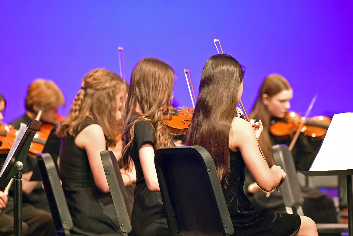 8th grade violinists take the stage at Whitefish Middle School's orchestra concert on Thursday. (Kelsey Evans/Whitefish Pilot).