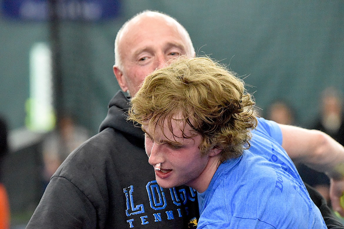 Libby's Ryan Beagle and Loggers assistant coach Terry Oedewaldt celebrate after Beagle beat Polson's Torin Ellis to win the Montana Class A tennis singles championships Friday, May 24, 2024. (Scott Shindledecker/The Western News)