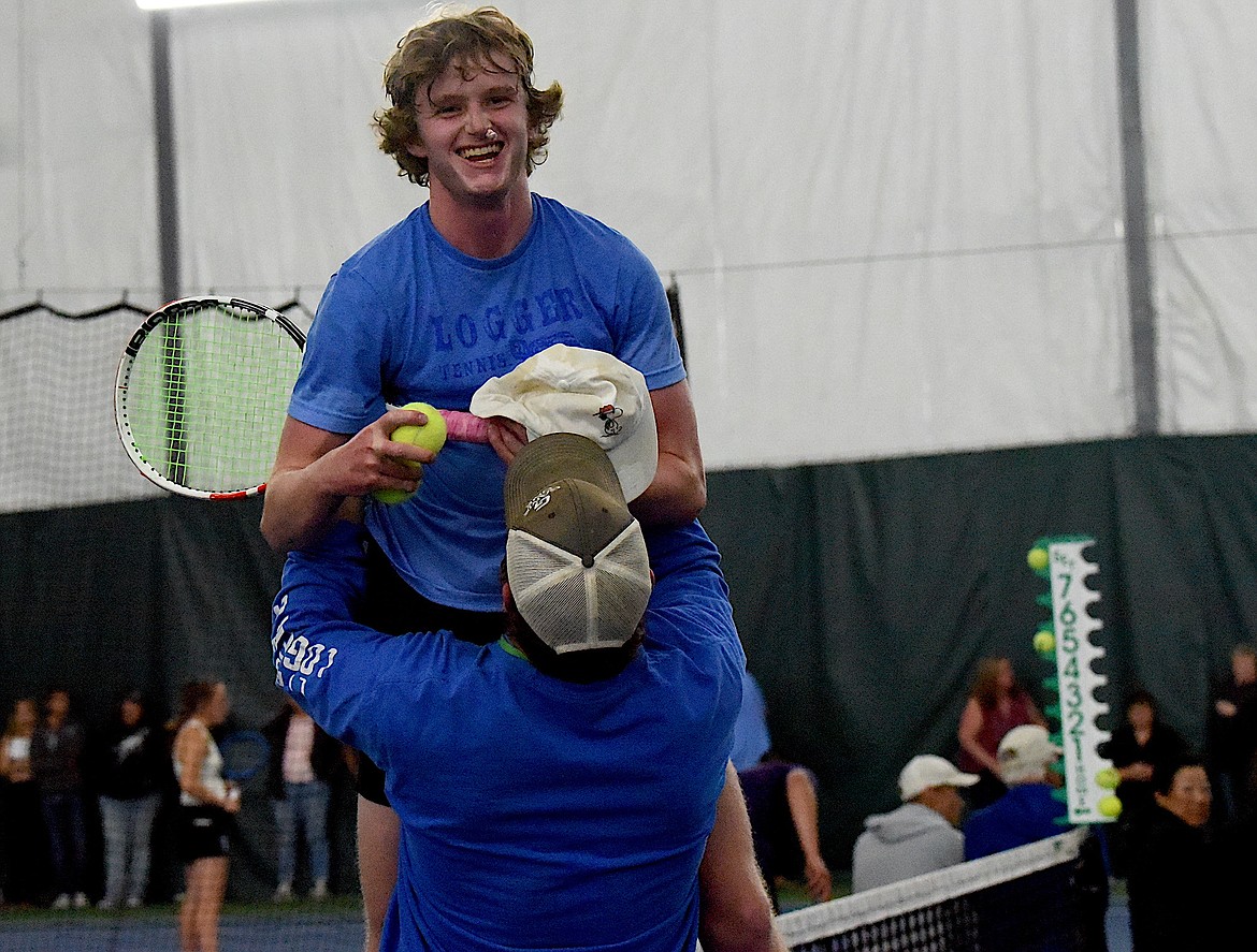 Libby head tennis coach Kyle Hannah lifts Montana Class A tennis singles champion Ryan Beagle in celebration after he beat Polson's Torin Ellis to win the title Friday, May 24, 2024. (Scott Shindledecker/The Western News)