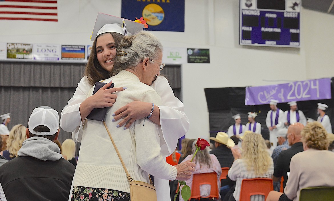 Charlo grad Darcy Coleman gives her grandmother, Anita, a big hug and a rose during Sunday's graduation celebration. (Kristi Niemeyer/Leader)