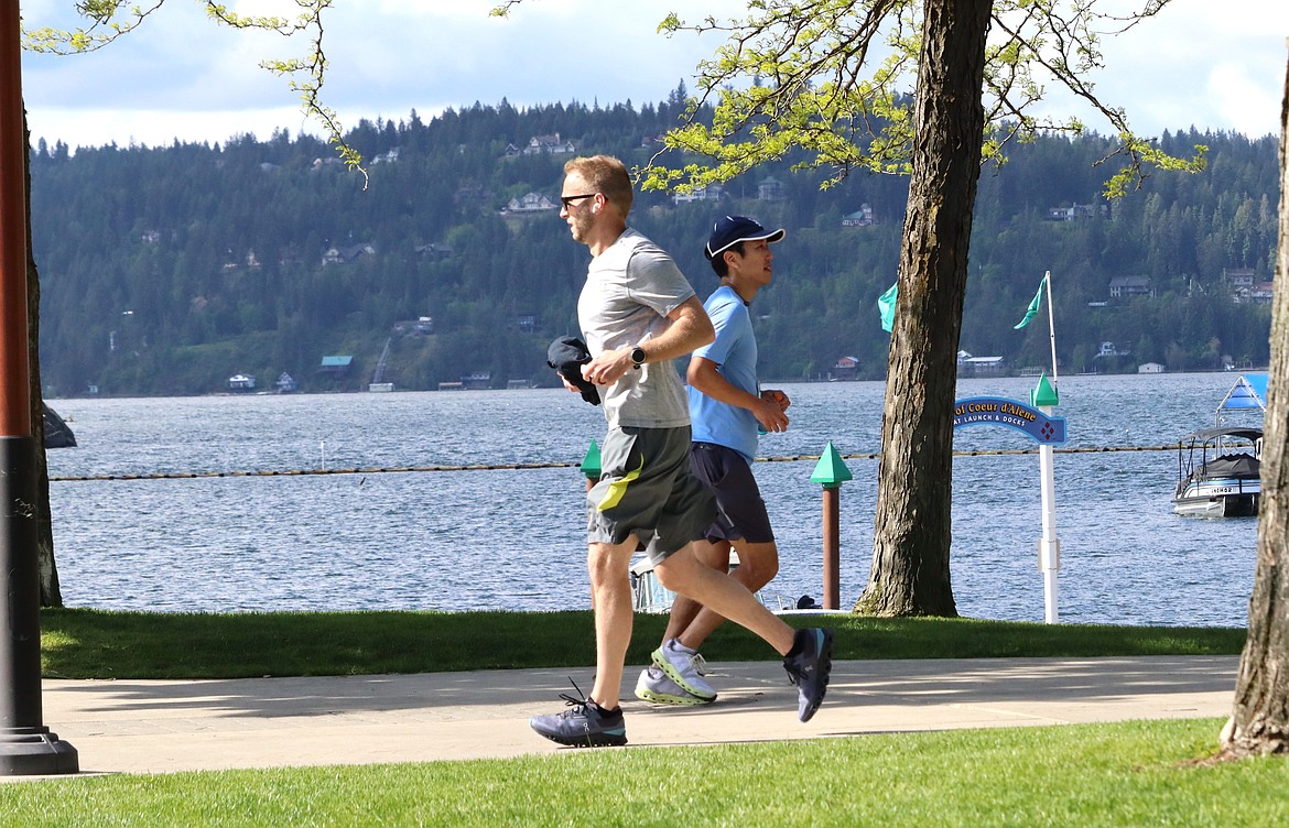 Runners past each other with Lake Coeur d'Alene in the background Sunday.