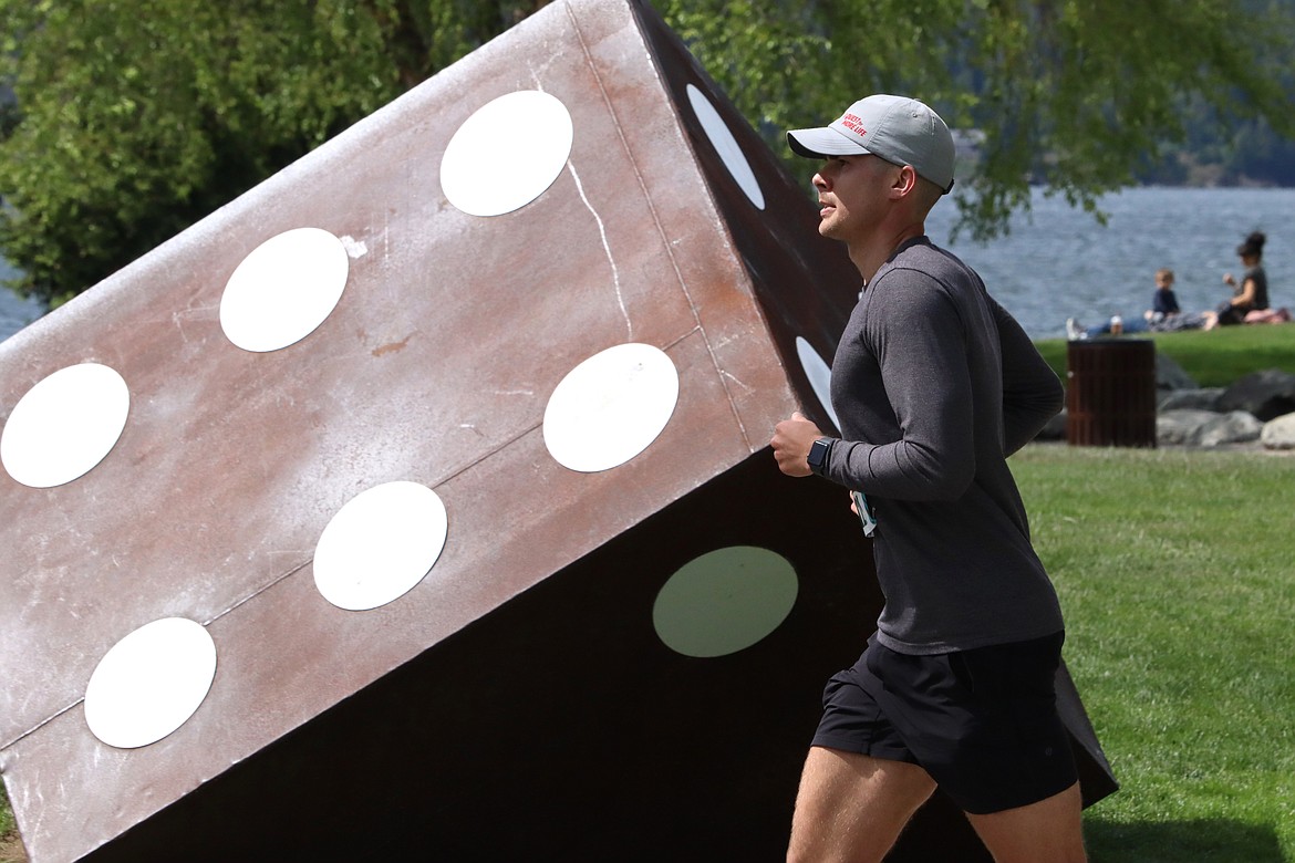 Jim Ruster of Spokane passes the dice at Independence Point as he closes in on the finish of the Coeur d'Alene Marathon on Sunday.