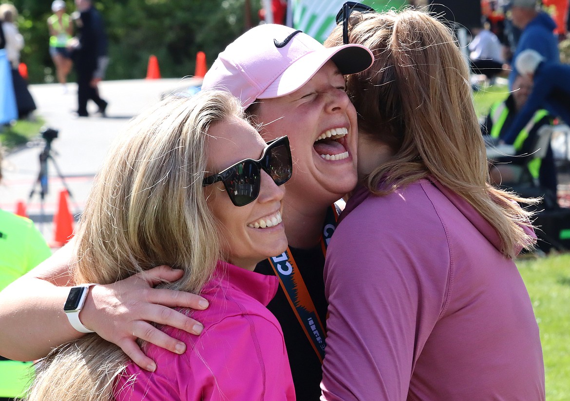 Jessica Tiengo, center, reacts after finishing the Coeur d'Alene half marathon at McEuen Park on Sunday. She is joined by friends Kelsey Erwin and Bonnie Brown.