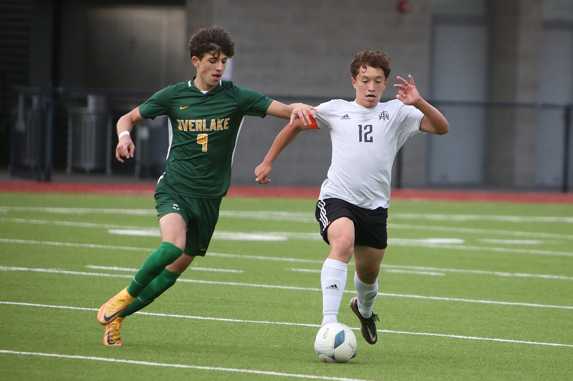 Royal senior Santiago Gonzalez (12) attempts to get past an Overlake defender during Saturday’s 1A state championship game against the Owls.