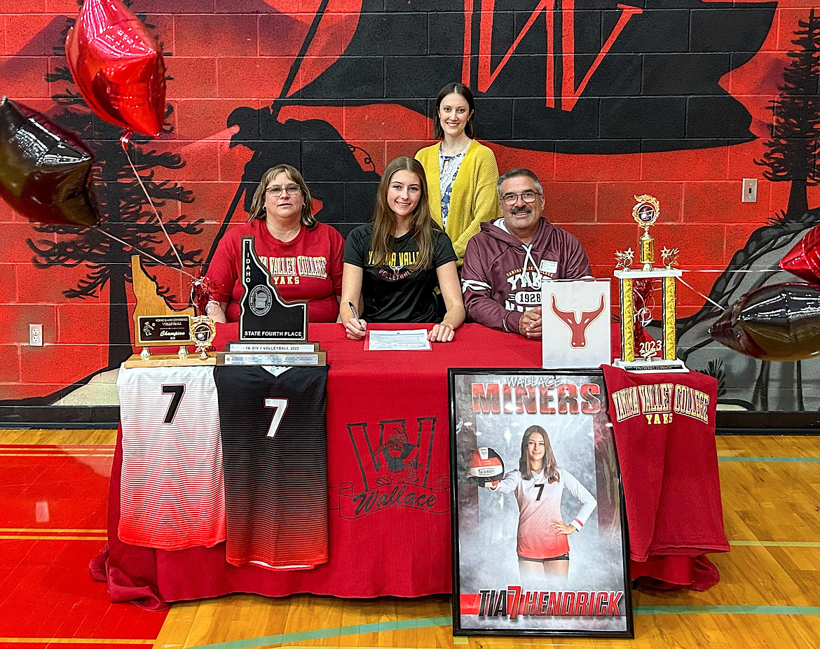 Wallace's Tia Hendrick, pictured here with her family and coach Katie Bauer, recently signed with Yakima Valley College to play volleyball for the Yaks.