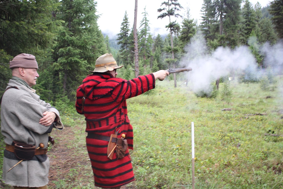 Ian Wolf from Spokane fires his .45 caliber Jukar on the range while his dad, Kevin, is the spotter. The Wild Horse Rendezvous is one of their favorites to attend. Both hunt with black powder and Kevin dropped a bull elk last year with a Flintlock that he built. (Monte Turner/Mineral Independent)