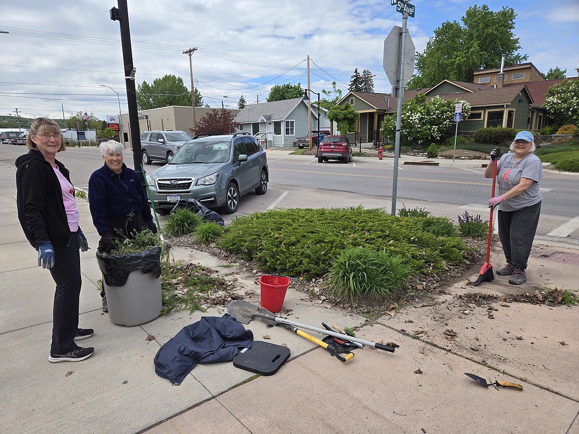 BUMP-OUT VOLUNTEERS Jeanne Doepke, Linda Greenwood and Gerry Browning cleaned, pruned, pulled weeds and deadheaded plants in the flowerbeds at the corner of 5th Ave. E. and Main Street recently. Volunteers maintain the corner flowerbeds along Main Street from May until September each year. Since a few helpers are no longer able to help, new recruits are needed. Call Suz Rittenhouse at 406-260-0480 to lend a hand. (Courtesy photo)