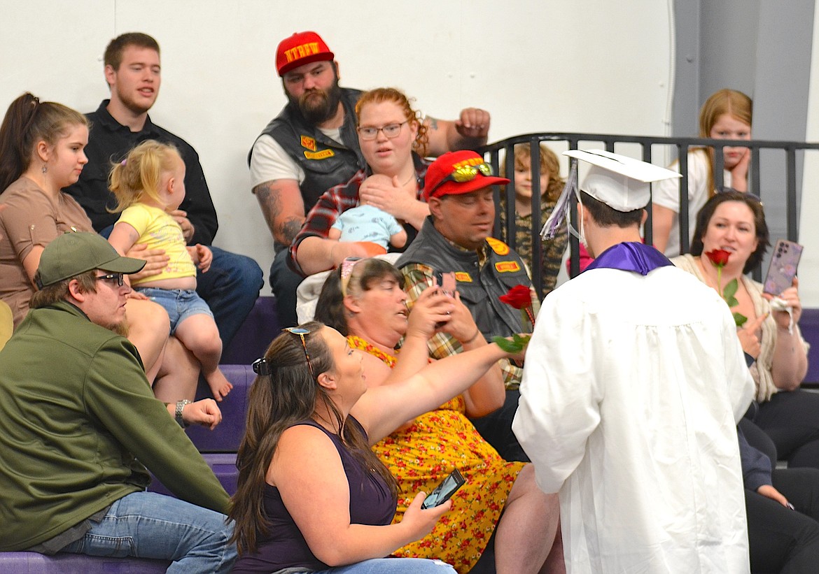 Surprised dad accepts a rose from his son, Kaden Bailey, during Sunday's graduation ceremony at the Charlo gym. (Kristi Niemeyer/Leader)