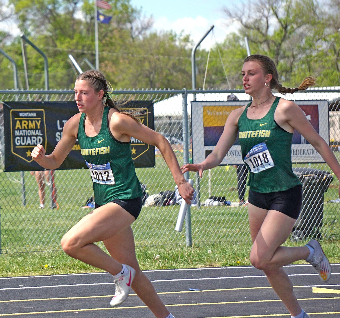 Hailey Ells (left) and teammate Rachel Wilmot execute the exchange en route to a first-place finish in the Woman's 4X100 relay at the MHSA Class A State meet on Saturday. (Matt Weller Photo)