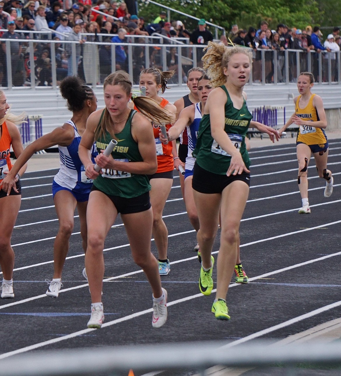 Freshman Anna Boysen (background) and teammate Hailey Ells compete in the Women's 4X400 relay at the MHSA State Track Meet on Saturday. Along with teammates Brooke Zetooney and Rachel Wilmot, the squad dominated both sprint relays. (Matt Weller Photo)