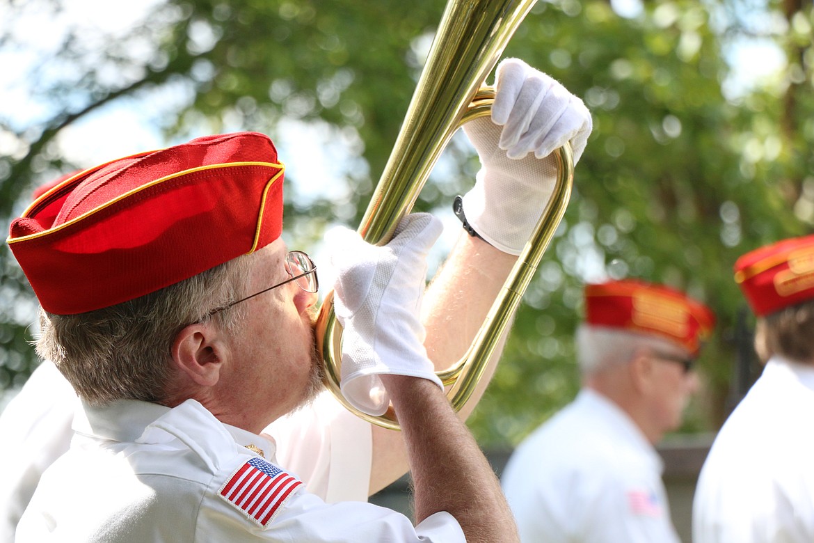 A member of the local Marine Corps League plays "Taps" on a bugle during Monday's Memorial Day service at Lakeview Cemetery. The tribute was the second of two community services to honor those who gave their lives in service to the United States.