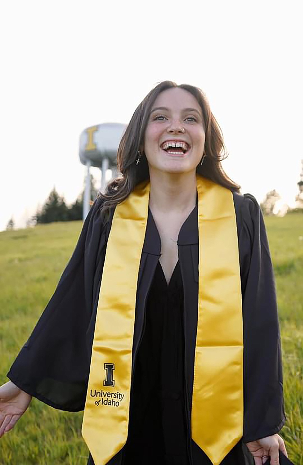 Emily Holbrook poses in her graduation garb after graduating the University of Idaho earlier this month.