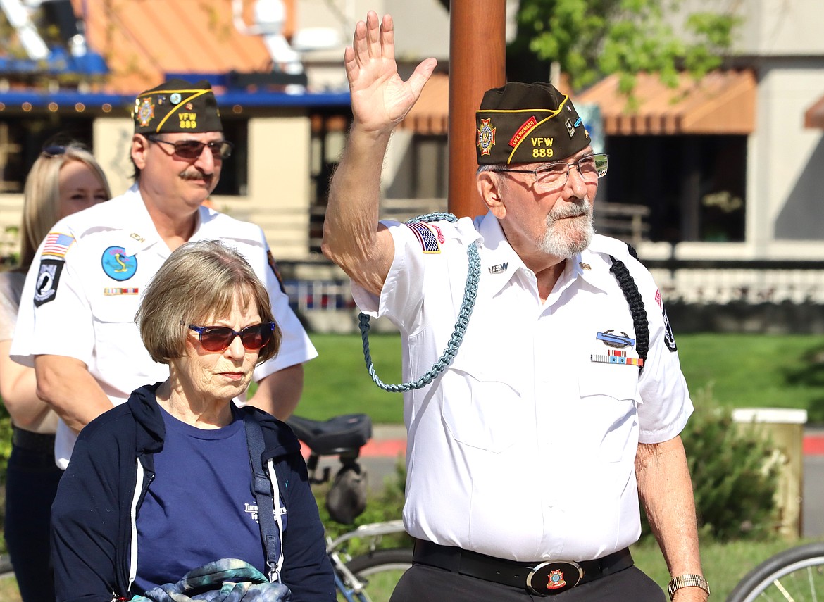 Veteran Charles Riffel raises his hand at McEuen Park Veterans Memorial Plaza on Monday.