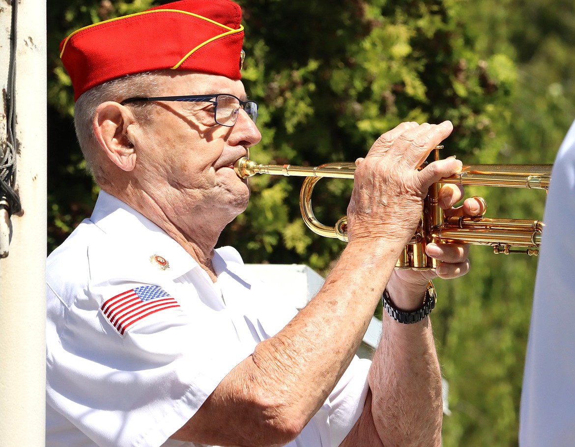 Veteran Bob Leatherwood plays taps at Coeur d'Alene Memorial Gardens on Monday.